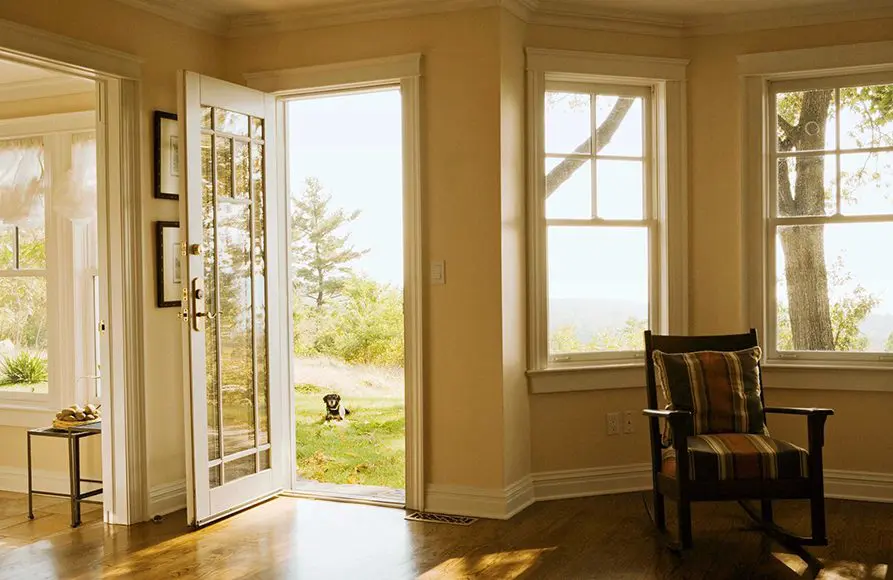 A room with a chair and open door