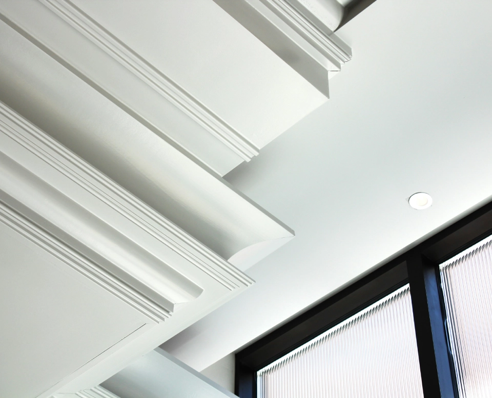 A white ceiling with many pieces of white plaster.